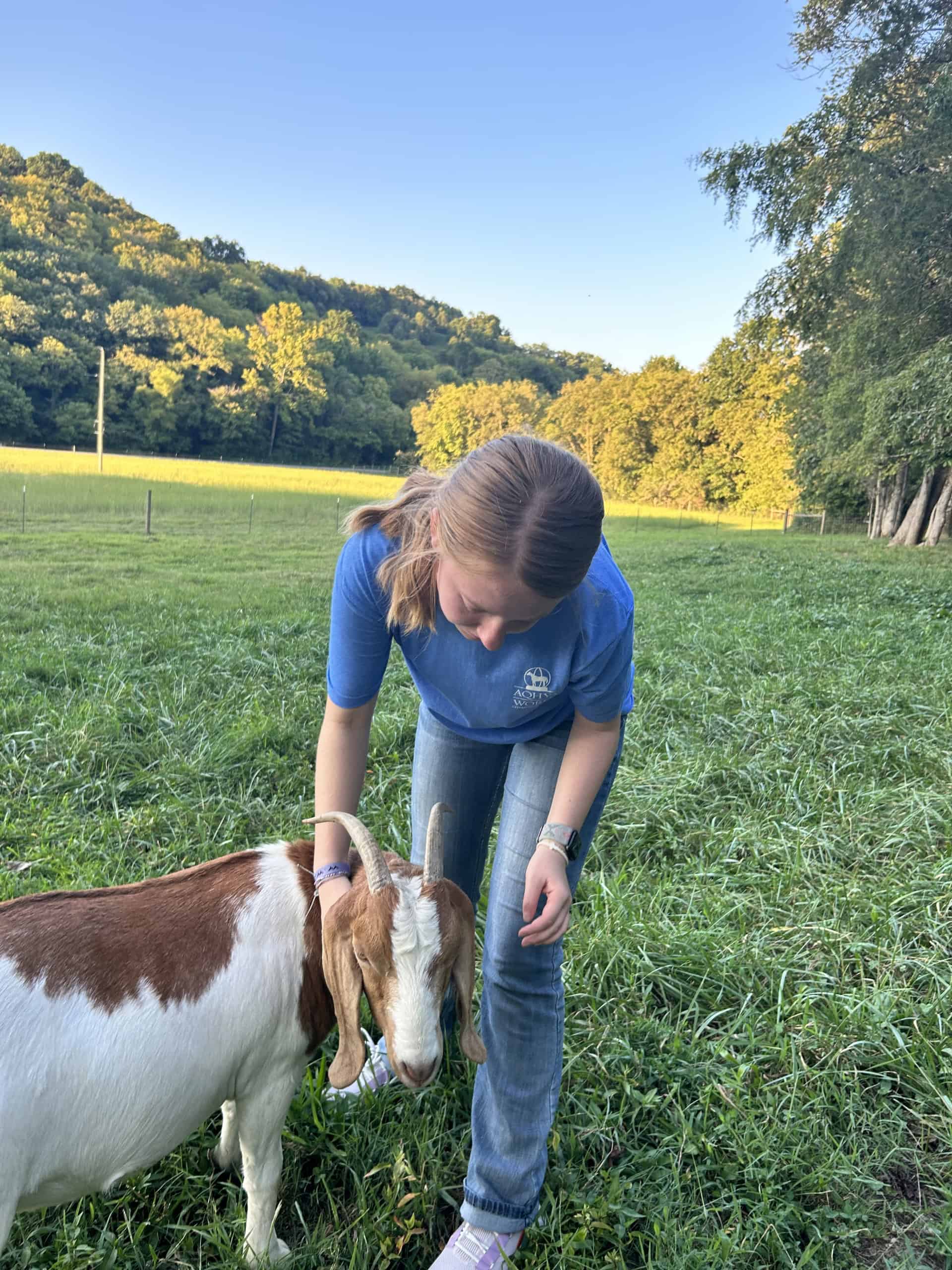 Libbey Logan checks on her goats in the evening.