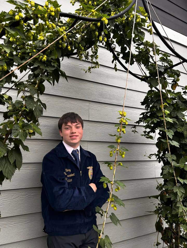 Shelton Highschool FFA Member, Lane Stoney stands behind his home grown Hops.