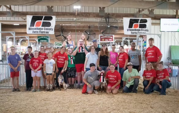 All participants and exhibitor volunteers smile for a photo after the Endless Adventures program event.