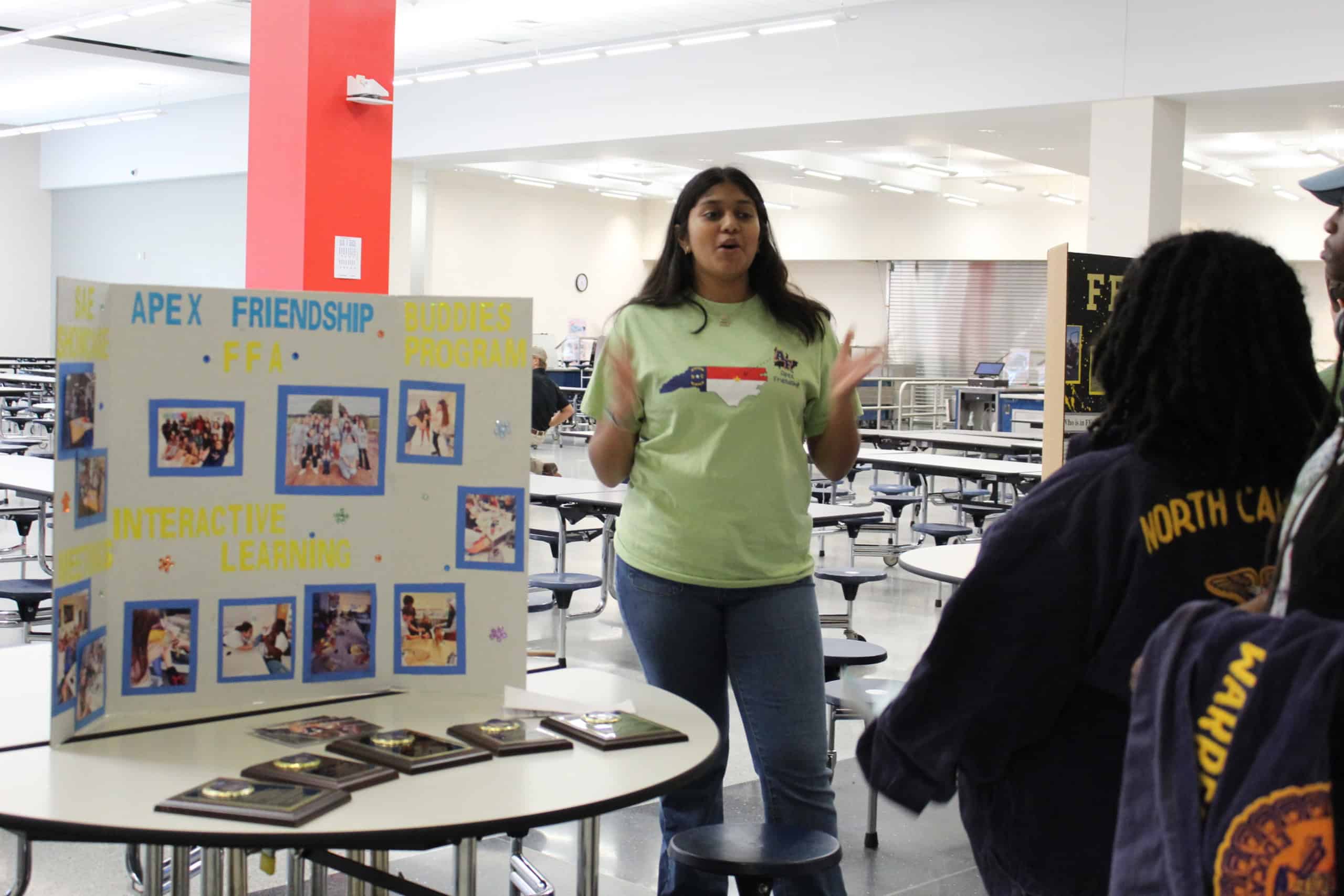 Student talking to other members at the Chapter Display Showcase.