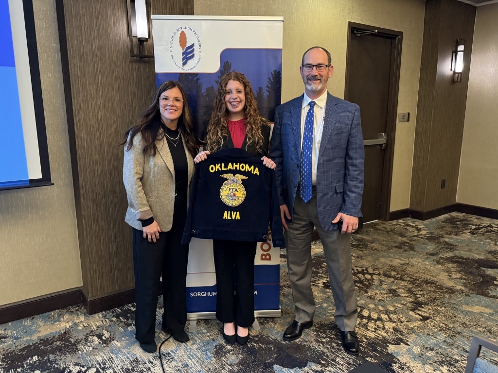 NSP Chairmen Amy France (left) and NSP CEO Tim Lust (right) take a photo with Alva FFA Chapter Reporter Katelee Martin (middle).