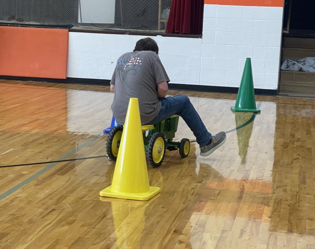 An FFA member participates in his chapter’s “Ag Olympics” pedal tractor racing competition.