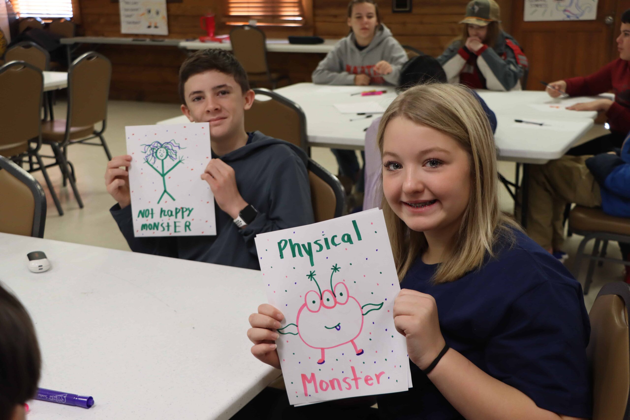Students are proud to showcase their work of art.