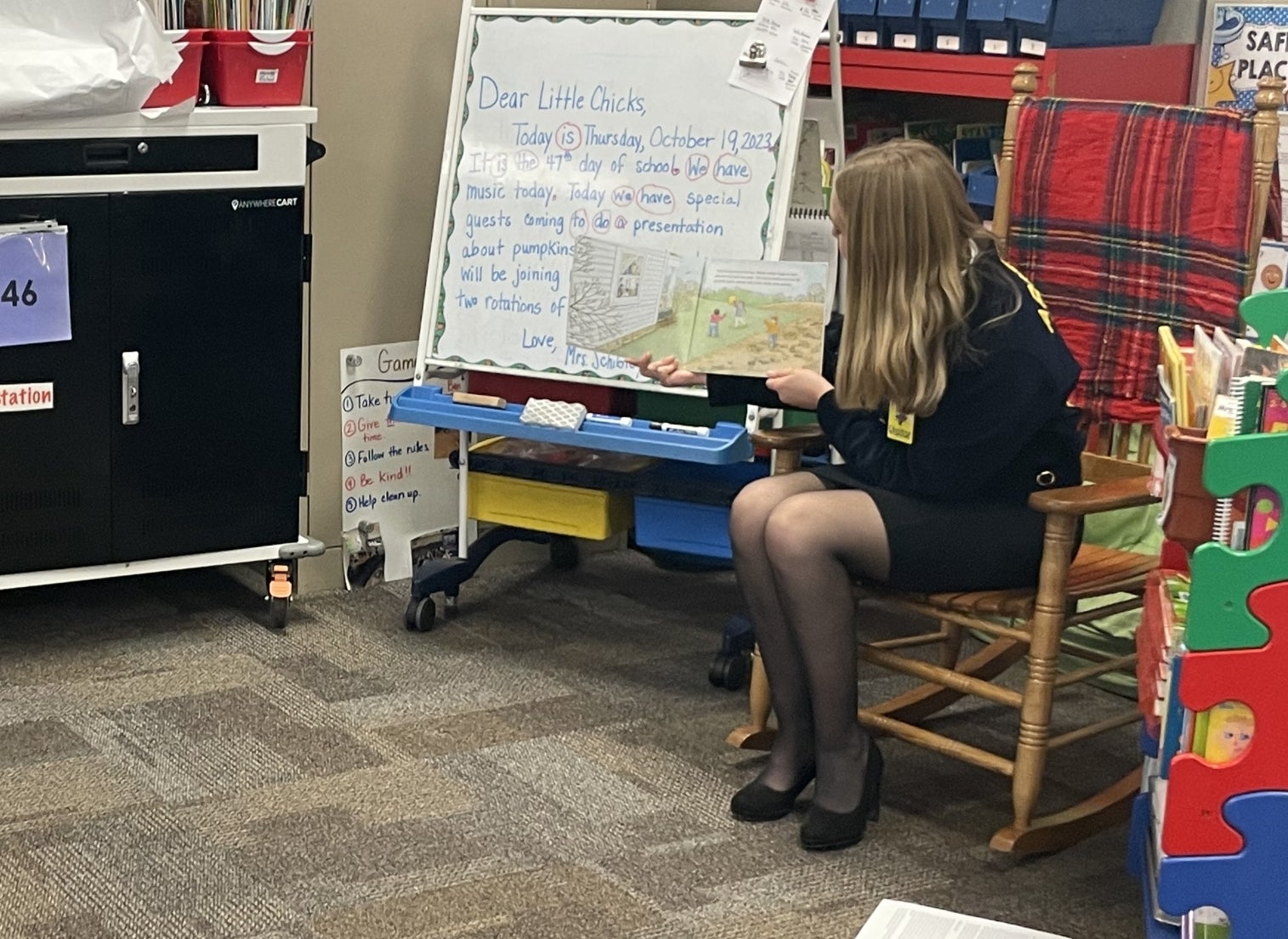 Emily Guenther, an AAEC-EM FFA member, reads a story during an Agriculture in the Classroom lesson.