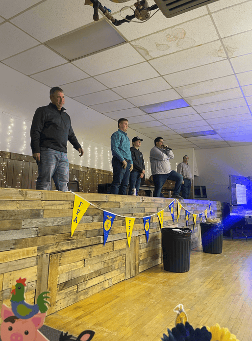 Junior high FFA members participate in the auction on stage.