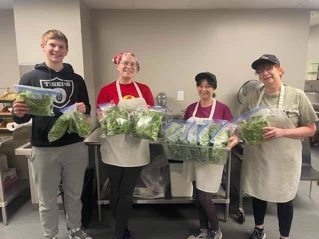 Kocher (far left) poses with the Richland County High School food service staff after he donated his lettuce for them to use for the week.