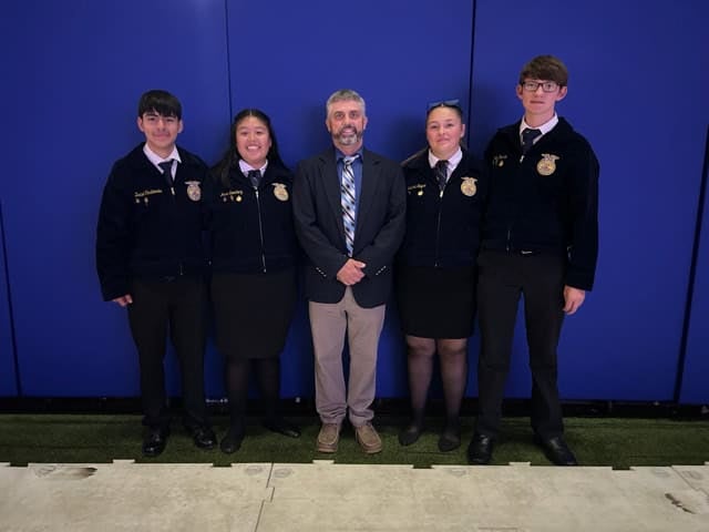 Sayre and his 2024 award-winning team prepares to be recognized on stage during the 97th National FFA Convention &amp; Expo. Photo courtesy of Jarred Sayre.