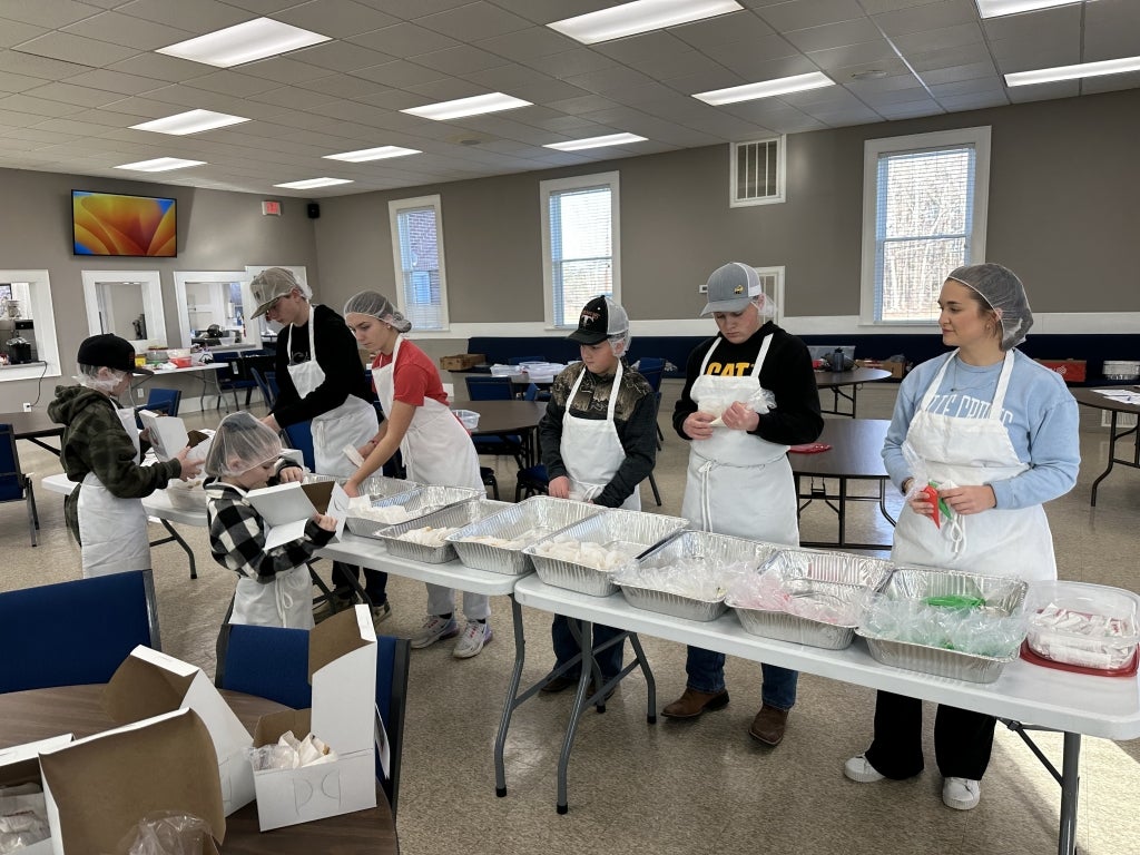 Members pack cookie decorating kits that will be sold to raise money for the Alicia Greer Memorial Scholarship.