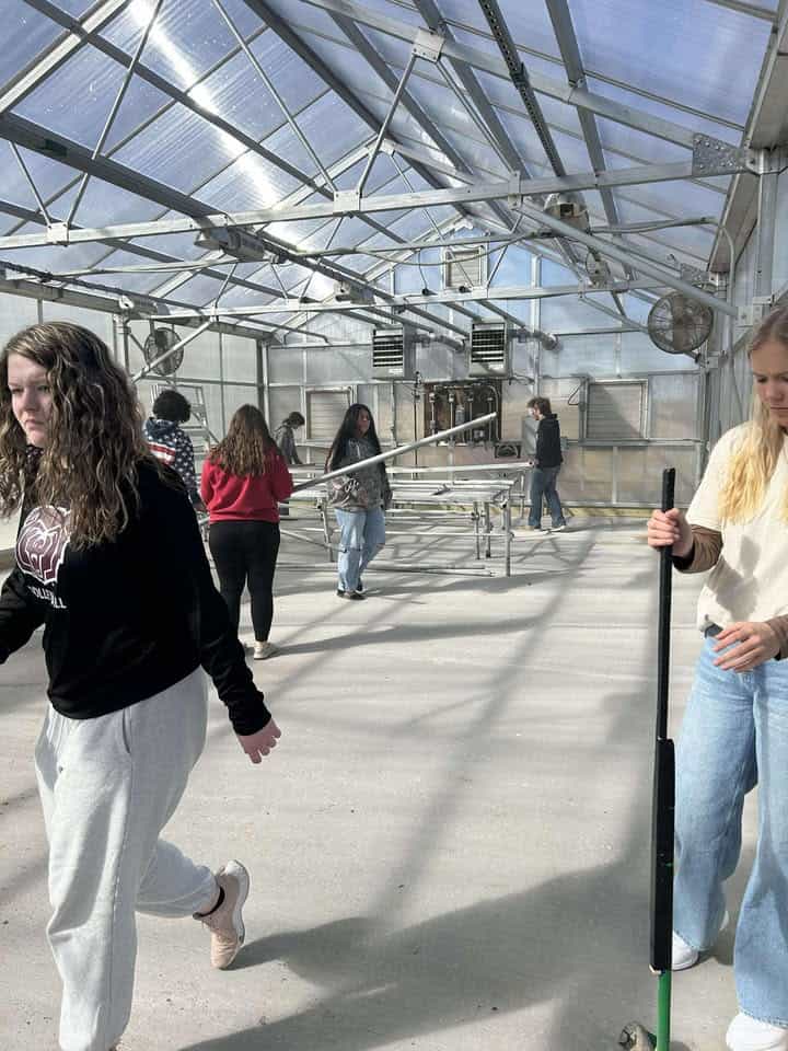 Ballard FFA members helping in their new greenhouse.