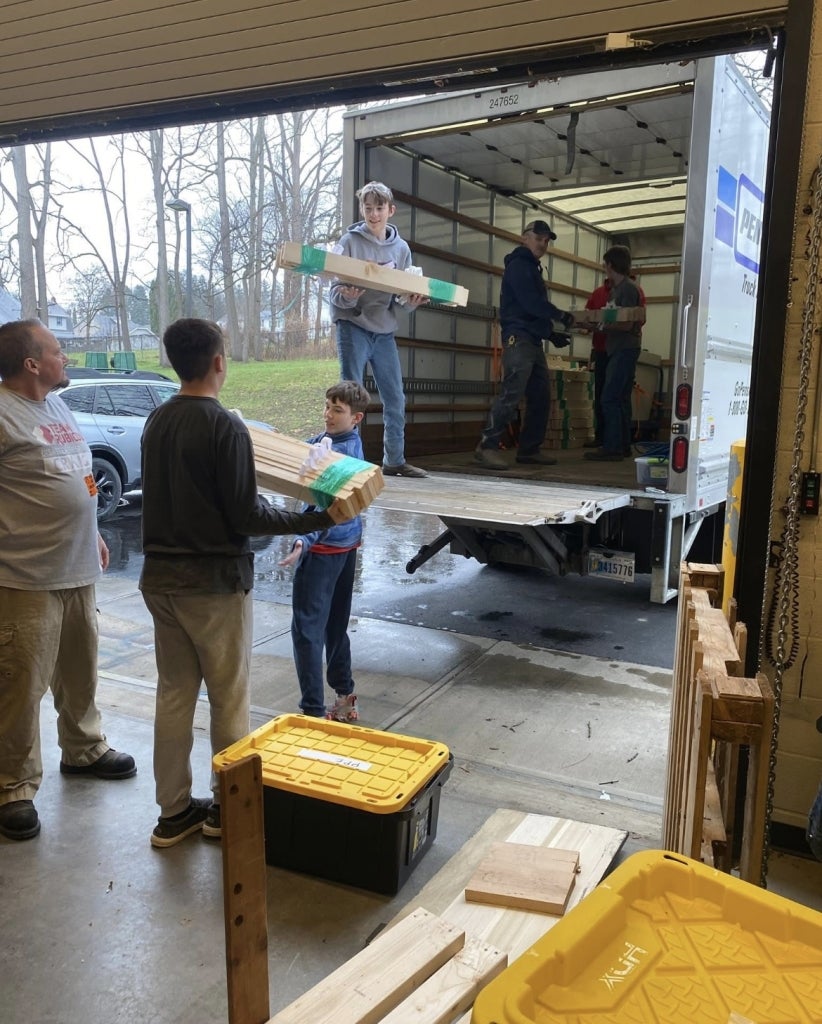 Finished bed frames are loaded into the truck.