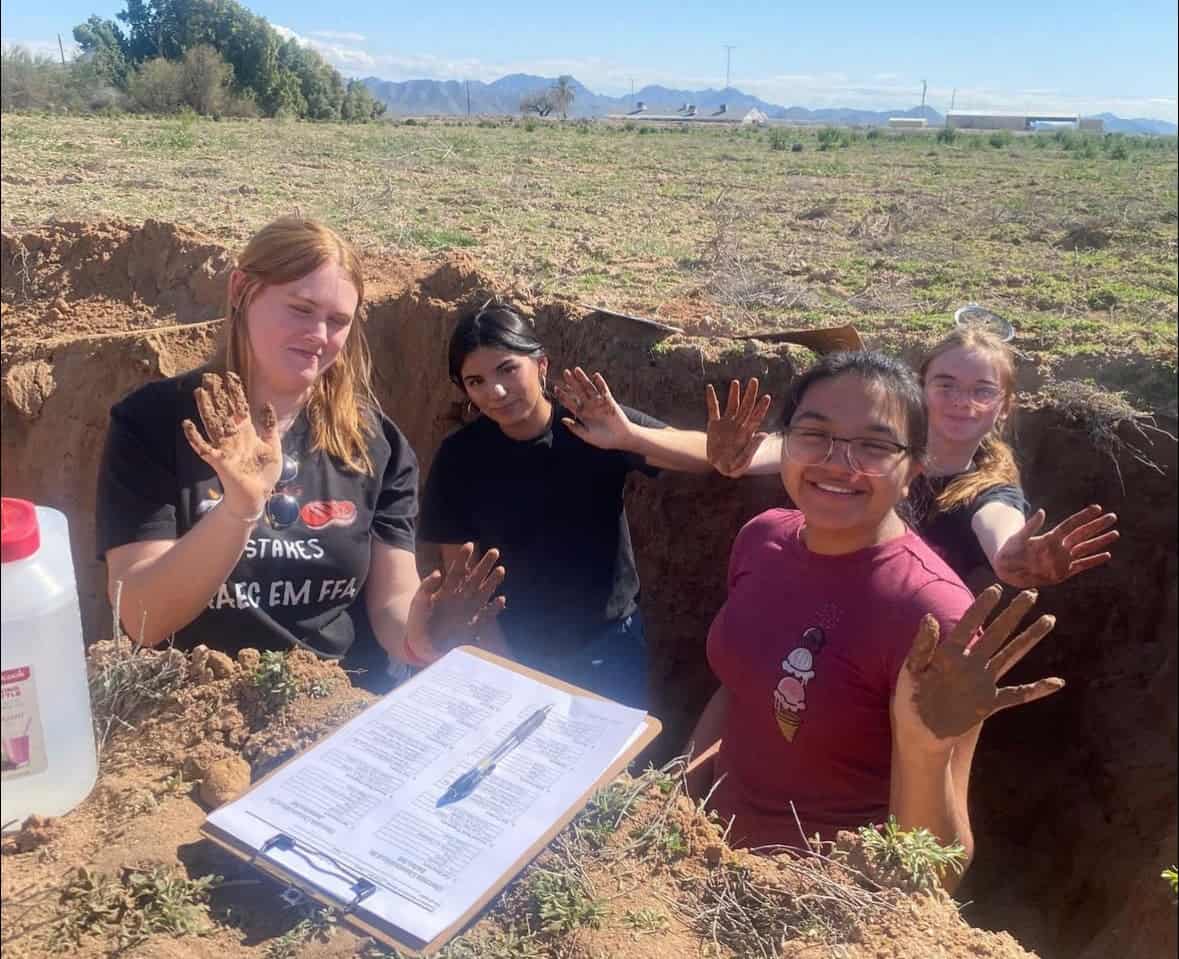 The 2023 AAEC-EM FFA Agronomy CDE team practices in a soils pit.