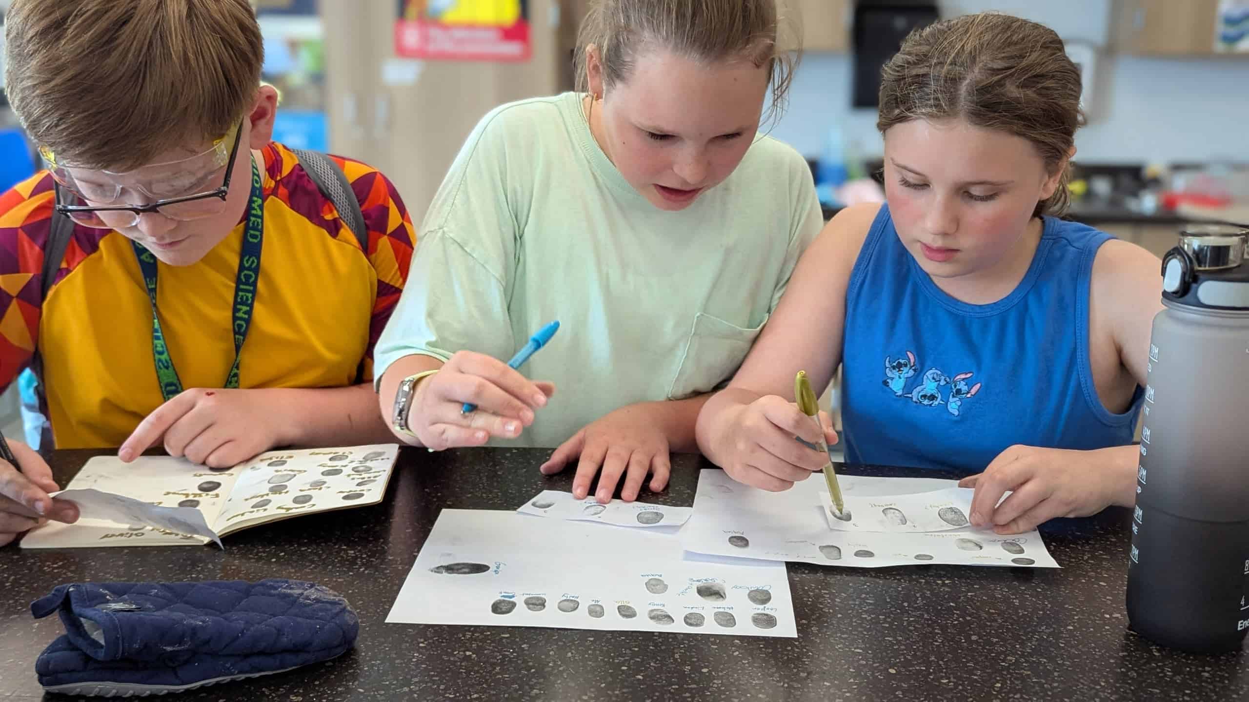 Students work together while learning about the different types of fingerprints.