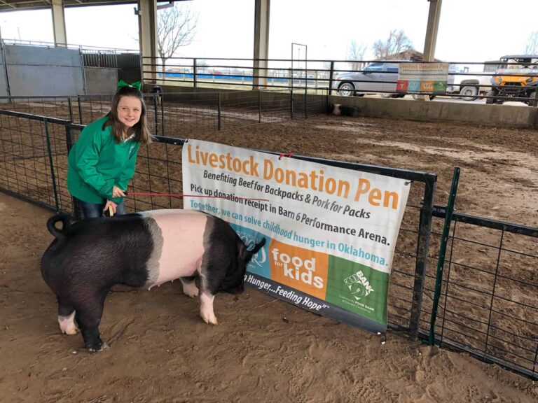 Maggie Carroll at eight years old donating her pig to Pork for Packs.