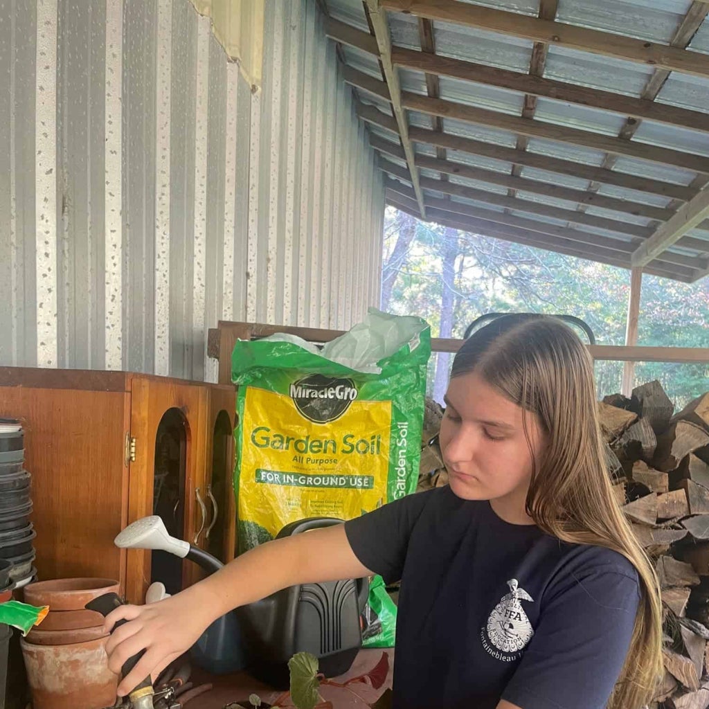Fontainebleau FFA member, Ariana Williams, works in her greenhouse to come up with creative ways to educate children. 