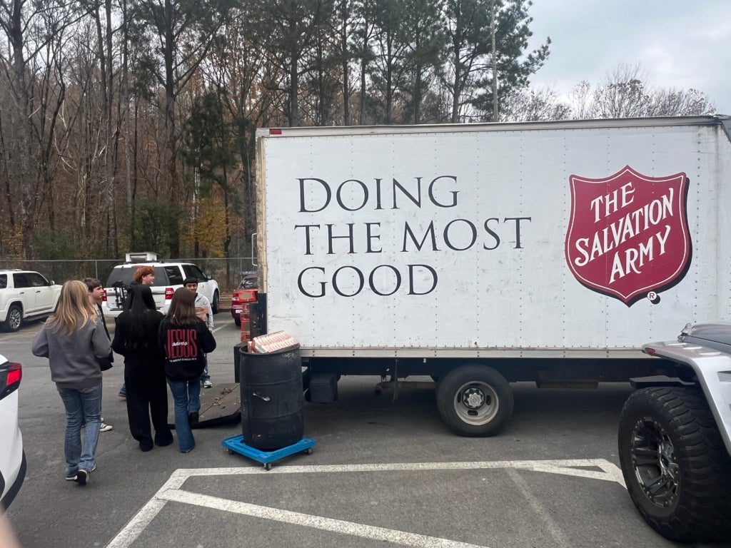 FFA members help load food cans into the Salvation Army truck.