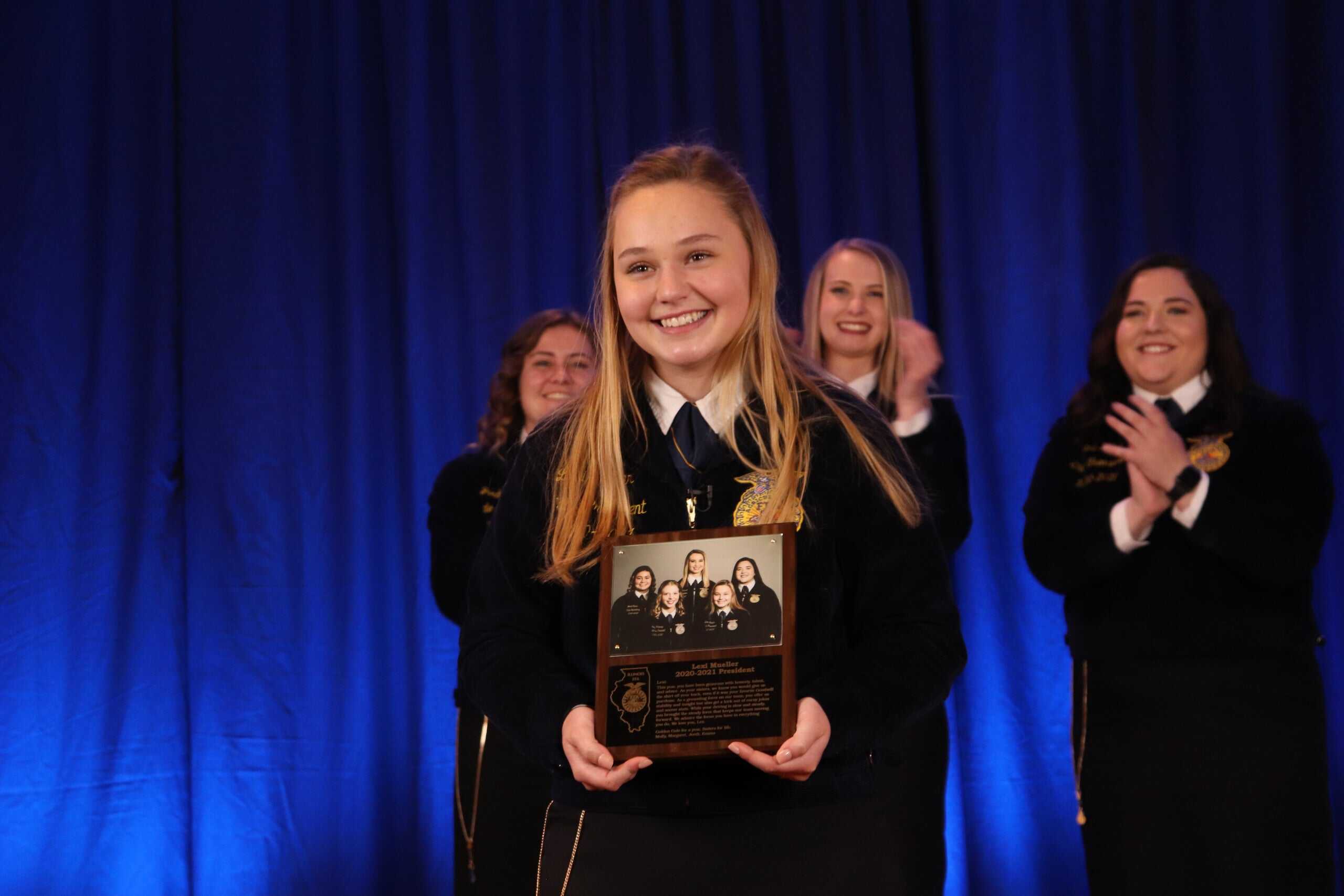 Mueller with her plaque that commemorates her year as a state officer. 