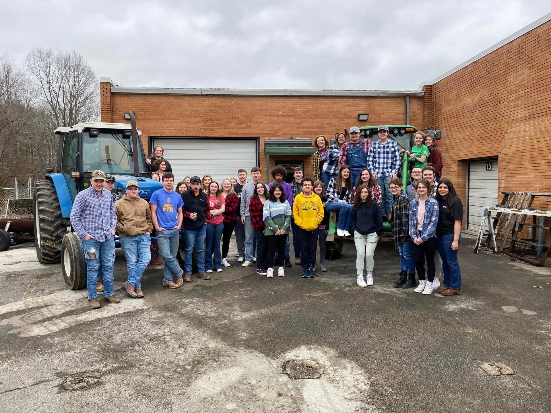 Green County FFA members pose with tractors on Drive Your Tractor to School Day. The members participated in the dress-up day, Flannel Friday.