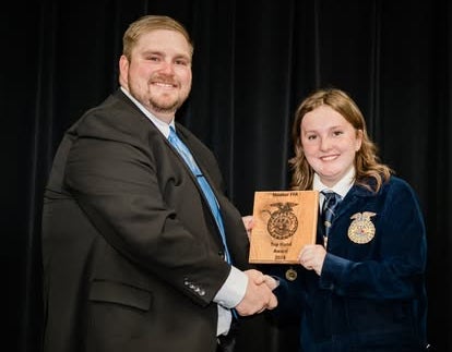 Johns and Brynna Raines celebrate her accomplishments. 