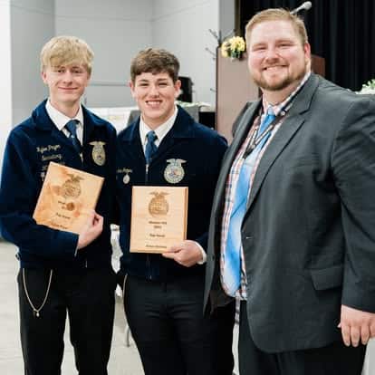 Rylee Pryor and Amos Grimes pictured with Johns. Lots of smiles after celebrating the year’s hard work.