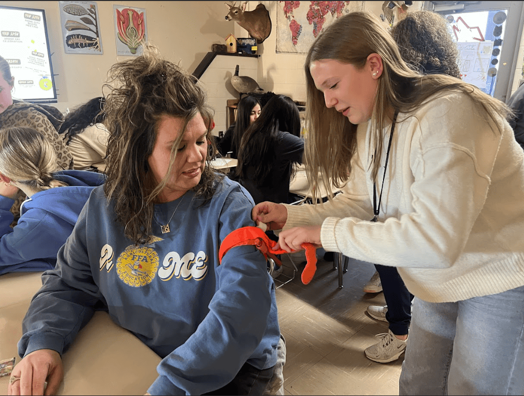 An FFA member practices on Mrs. Hamby, the Rome Middle School FFA advisor.