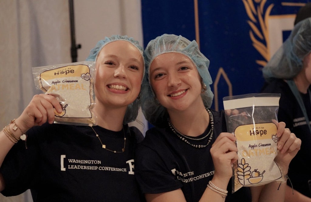Emma Hefferman and Natalie Zwilling loaded meals at WLC. 