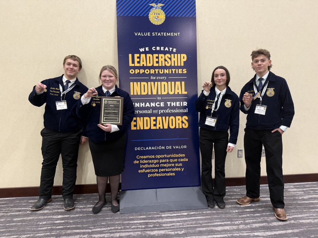Team poses for a photo with their plaque and medals at the 2025 National FFA Convention.